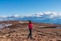 Ladinger Spitz - Woman with ear flap hat standing on alpine meadow with scenic view on Grosser Sauofen (Ebersteiner Sau)