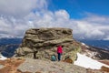 Ladinger Spitz - Woman with a hiking backpack next to massive rock on summit Gertrusk on the way near Ladinger Spitz, Saualpe Royalty Free Stock Photo