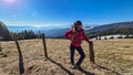 Ladinger Spitz - Woman on hiking trail standing next to fence on alpine meadow near Ladinger Spitz, Saualpe, Lavanttal Alps Royalty Free Stock Photo