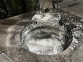 a ladle in an aluminum melting furnace in an installation of an aluminum die casting injector, in the furnace the molten material