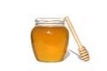 Fresh honey in a jar with a wooden dipper on a white isolated background. Royalty Free Stock Photo