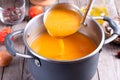 Ladle scooping butternut squash soup from a pot