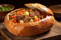 ladling beef stew into a bread bowl Royalty Free Stock Photo