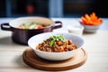 ladling chili con carne from pot to bowl Royalty Free Stock Photo