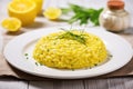 ladling risotto milanese onto a white ceramic plate