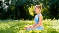 Lady athlete in blue tracksuit practices yoga sitting in relaxation pose