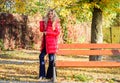 Lady attractive fashionista posing in jacket. Woman fashionable blonde with makeup stand in autumnal park. Jacket for