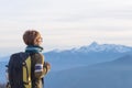 Lady with backpack looking at majestic panorama on the Alps Royalty Free Stock Photo