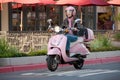 Lady biker on pink scooter Royalty Free Stock Photo