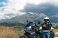 Lady Biker on road, travel motorcycle, summer adventure, active lifestyle, vacation concept Magliano de Marsi, on background