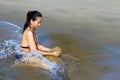 Lady bikini play sand and wave Royalty Free Stock Photo