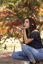 A lady blowing petals of Tabachin Tree Royalty Free Stock Photo