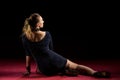 Lady in blue gown standing and posing in studio. Portrait of beautiful elegant woman in shining evening dress.