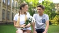 Lady with bouquet of flowers looking with love at boyfriend, romantic present