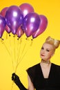 Lady with a bunch of purple balloons Royalty Free Stock Photo