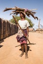 Lady carrying wood