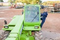 Lady climbing into telehandler