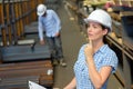 Lady with clipboard wearing hardhat