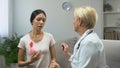 Lady consulting with mammologist, finding tumor in breast, cancer prevention