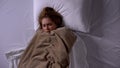 Lady covered with blanket lying in bed, feeling fever, symptoms of cold, illness