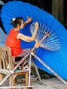 Lady crafting an Thailand Traditional Borsang Umbrella in Chiang Mai