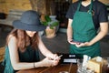 Lady customer holding phone near nfc terminal make contactless mobile paymen