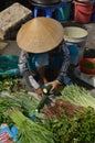 Lady cutting courgette in Can Tho food market, Vietnam Royalty Free Stock Photo