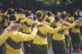 The lady dancing in traditional yellow clothes