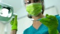 Lady dentist holding glass, preparing for teeth examination, patient POV