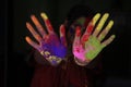 A lady displaying colured palm during holi festival in india