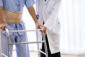 Doctor help elderly using adult walker
