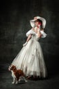 Lady with dog. Vintage portrait of young elegant woman in image of medieval person in renaissance style dress Royalty Free Stock Photo