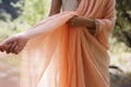 lady draping peach pashmina shawl