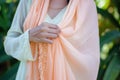 lady draping peach pashmina shawl