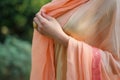 lady draping peach pashmina shawl
