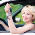 Lady, driving showing car keys out the window. Royalty Free Stock Photo