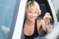 Lady, driving showing car keys out the window. Royalty Free Stock Photo