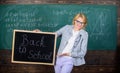 Lady educator in classroom prepare for new school year. Beginning of new school season. Woman teacher formal suit holds