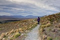 A lady enjoying beautiful landscape of Lake Tekapo.