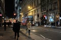 A lady enjoying a walk at night in central London, Uk