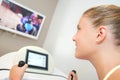 Lady on exercise machine watching TV screen Royalty Free Stock Photo