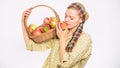 Lady farmer gardener proud of her harvest. Woman gardener rustic style hold basket with apples white background. Eco Royalty Free Stock Photo