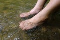 Lady feet steep into the stream Royalty Free Stock Photo