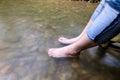 Lady feet steep into the stream Royalty Free Stock Photo