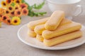 Lady finger biscuits, Italian dessert and sponge cookie on white plate and coffee cup Royalty Free Stock Photo