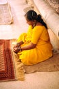 A lady finishes a carpet by hand. Jaipur, India. Royalty Free Stock Photo