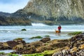 Lady fishing the surf