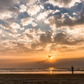 Lady flying a kite on the sunset on Goa beach Royalty Free Stock Photo