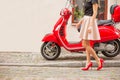 Lady in front of red moto scooter Royalty Free Stock Photo