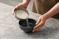 Woman preparing rice water on table